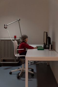 Kid in EEG cap looking at monitor in laboratory