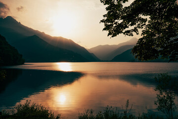 view of the lake in the alps on a summer sunset