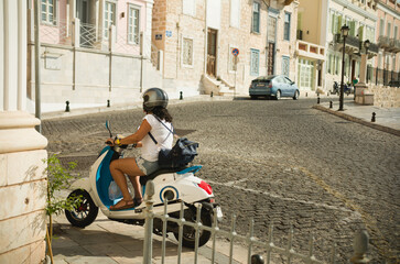 Electric scooter in gorgeous Ermoupolis most attractive cities in Cyclades, capital of Syros neoclassical mansions of exquisite taste and elegance, beautiful churches, and romantic alleys