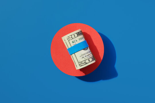 Roll of $20 USA Bills on Red and Blue 