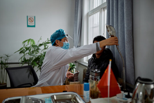 Doctor performing a test on a teenager at the hospital