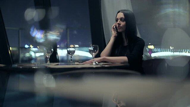 the girl from the restaurant speaks on the phone. night, st. petersburg, boat trip