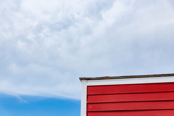 A red wood house in the corner 