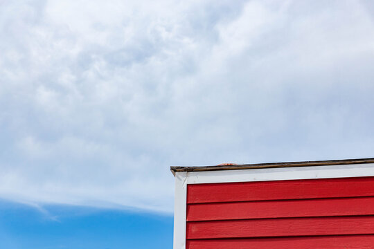 A red wood house in the corner 