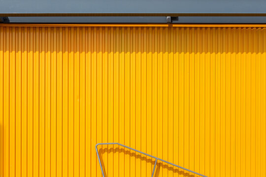 yellow wall with a piece of railing
