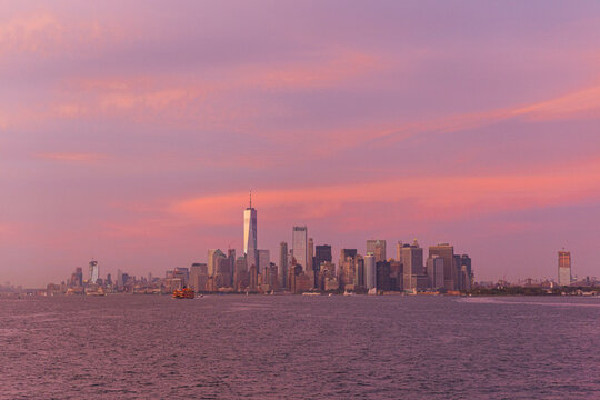 Buildings from New York over the sea in a sunset