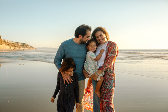 Joyful family with two daughters at beach