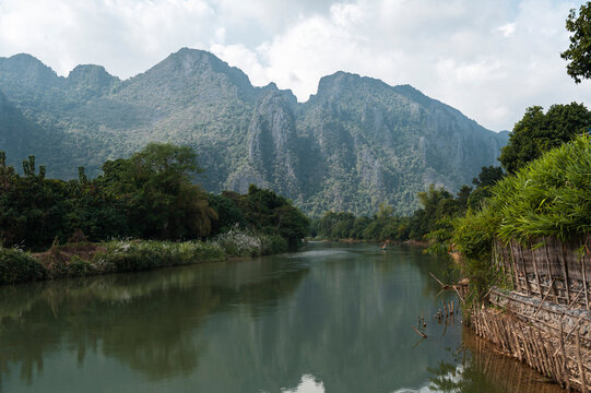 Nam Song River Bank And Mountain Range In Vang Vieng