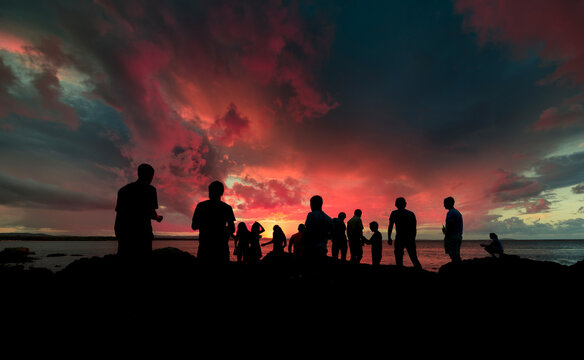 Friends gathering silhouettes at sunset