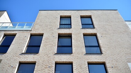 Obraz premium Modern european residential architecture on a sunny day. Exterior of new multi-story residential building. Concept of sale and rental of apartments for consumers .Modern windows and balconies.