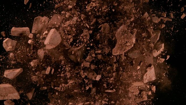 Super slow motion of rotating group of raw chocolate pieces on black background. Filmed on high speed cinema camera, 1000fps.