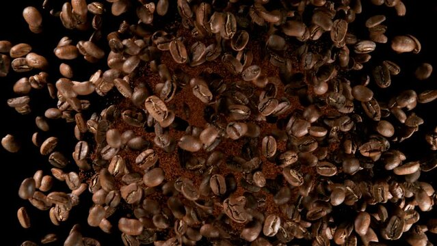 Super slow motion of rotating coffee beans on black background. Filmed on high speed cinema camera, 1000 fps.