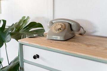 Detail of chest of drawers with vintage dial phone