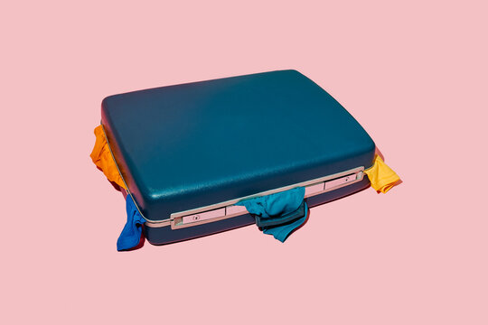 blue retro suitcase full of clothes