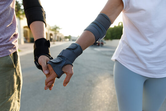 Holding hands on roller blades