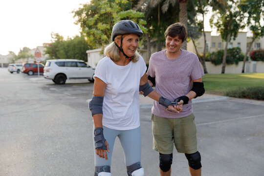 A man and his elderly mother on roller blades