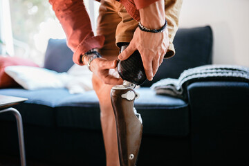 Faceless person fixating prosthetic leg
