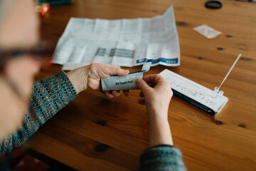 Anonymous person taking a rapid test at home
