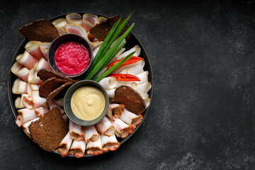 Fototapeta na wymiar Ukrainian appetizer, lard, bacon, horseradish, mustard, onion and rye bread