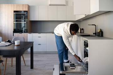 Man Loading Dishwasher