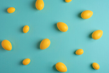 Yellow eggs on blue background. Easter concept. Texture