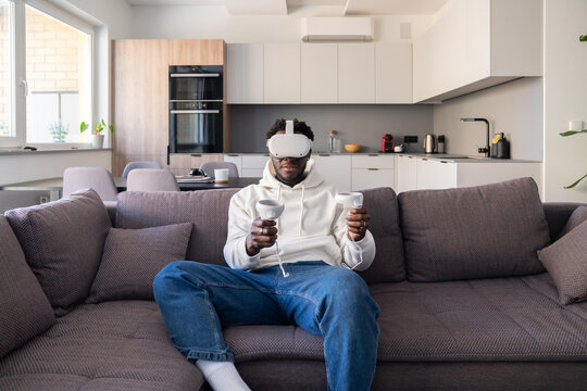 Man Using 3D Virtual Reality Glasses At Home
