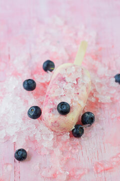 Blueberry and lime popsicle with fresh berries