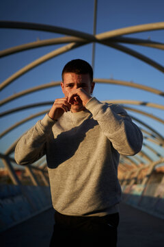 Sportsman in fighting stance on bridge