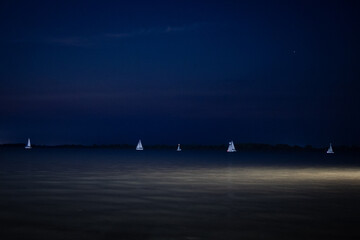 Boats at night sailing in the river 