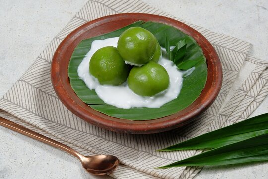 Kue Putri Mandi or badak berendam Are Steamed glutinous rice balls filled with coconut brown sugar paste and serve with coconut milk porridge.