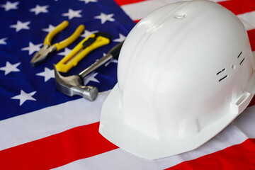 USA flag with helmet and construction tools. Happy Labor day.
