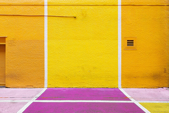 yellow wall on the street with white lines