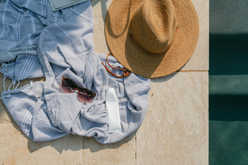 Towel and hat poolside