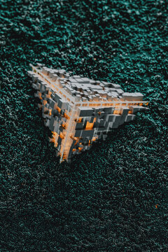 Orange Tech cube surrounded by electromagnetic particles