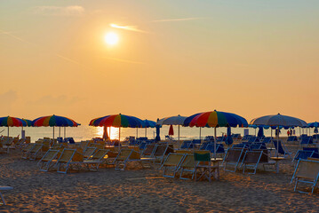 Umbrellas and sunbeds on the beach of Rimini in Italy - obrazy, fototapety, plakaty