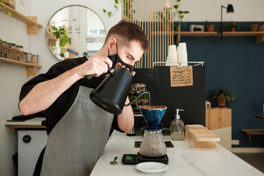 Barista making specialty coffee in a cafe