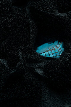 Blue Tech cube surrounded by electromagnetic particles
