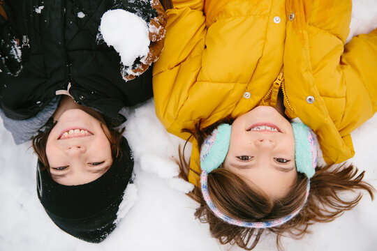 overhead view of kids laying in snow