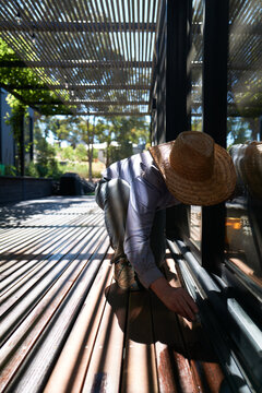 Homeowner maintaining timber deck