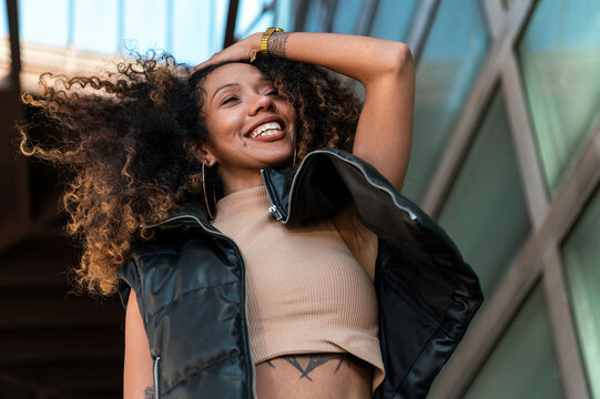 Energetic woman with afro hair showing positive emotion