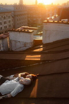 Couple in love on the roof at sunset