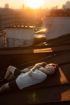 Couple in love on the roof at sunset