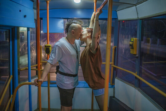 Couple in love kissing on the bus at night