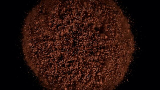 Super slow motion of ground coffee powder rotation on black background. Filmed on high speed cinema camera, 1000fps.