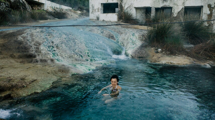 woman soaking in natural pool