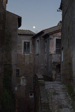 Moonrise in the old Italian city in winter