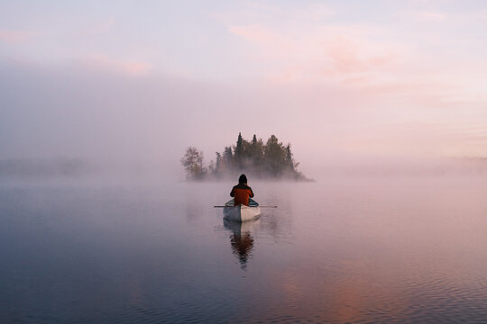 Man in canoe at sunrise
