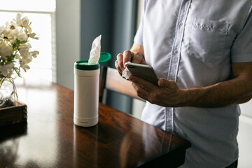Man Sanitizing Phone Against Virus And Disease