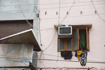 Clothes hanging from a window. 