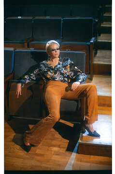 A girl poses in an empty movie theater
